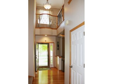 2-story foyer shows wood floors, solid 6-panel doo
