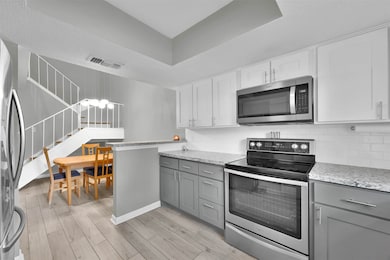 Stainless steel refrigerator stays with home.