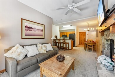 Living room with a fireplace, ceiling fan with not