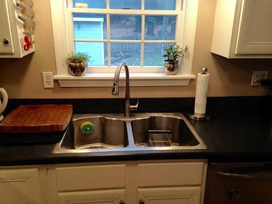 Kitchen. Large stainless sink comes...