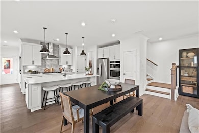 Dining space featuring recessed lighting, stairway, wood finished floors, and ornamental molding