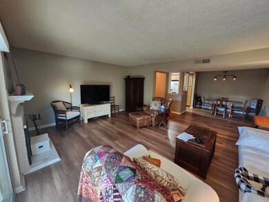 Living room featuring wood finished floors, a text