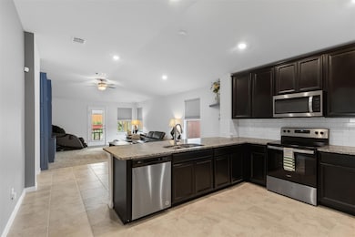 Kitchen with stainless steel appliances, a penins