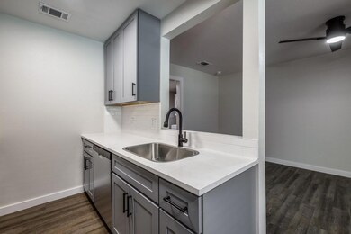 Kitchen with gray cabinets, stainless steel dishwa
