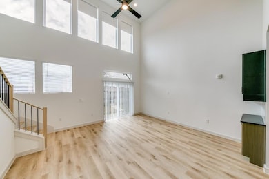 Unfurnished living room featuring stairway, a ceil