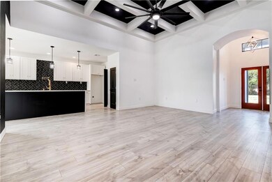 living room with view of kitchen and front door
