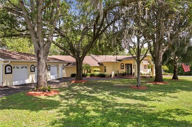 The home is nestled under several mature Oak trees