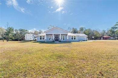 Rear view of house featuring covered porch and a y