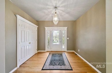 Entrance foyer featuring light wood-style floors