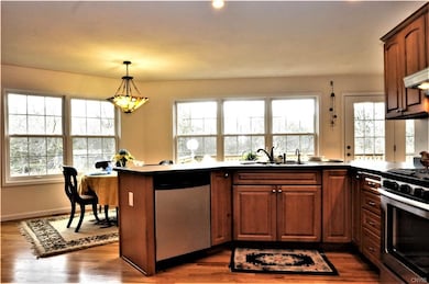 Kitchen boasts solid surface countertops, stainles