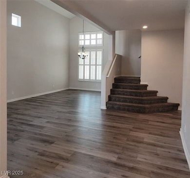 Stairway featuring a chandelier, healthy amount of