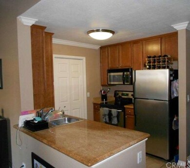 Kitchen With Granite Counters and Side Laundry Roo
