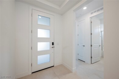 Entrance foyer featuring light tile patterned flooring and recessed lighting