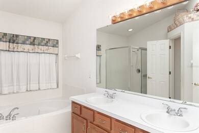 The large vanity supports two sinks and provides t
