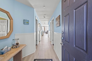 Hallway with light hardwood / wood-style flooring