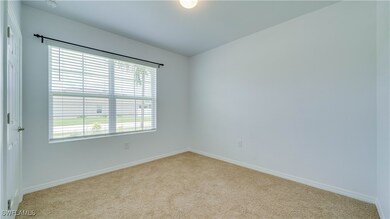 Unfurnished room with carpet and baseboards