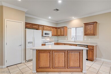Kitchen with white appliances, a kitchen island, l