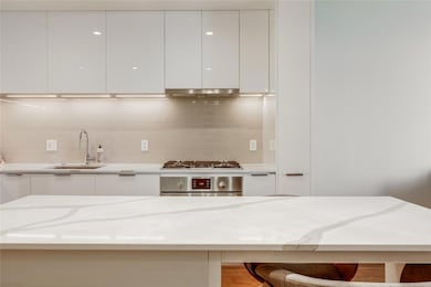 Kitchen with modern cabinets, oven, a sink, and w