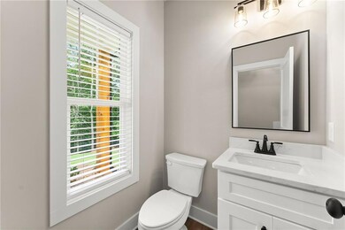 Half bath featuring vanity and plenty of natural light