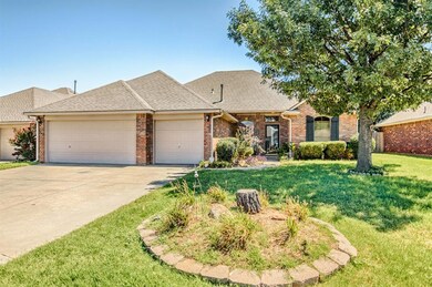 Ranch-style house with a front yard and a garage