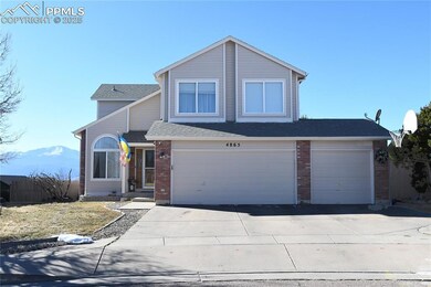 Front facade with a garage and a mountain view