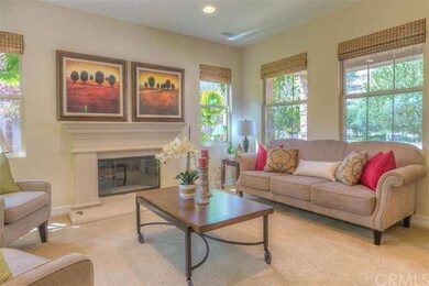 Formal room that is bright with fireplace & textur