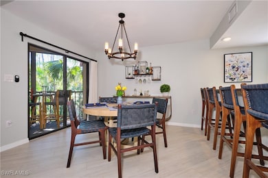 Dining area with a stylish chandelier, recessed li