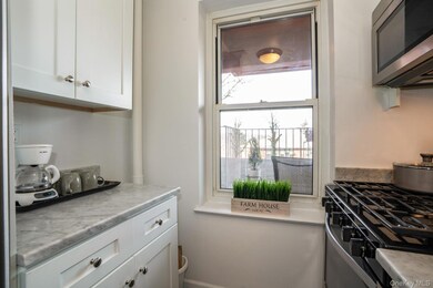 Kitchen featuring white cabinetry, stainless steel appliances.