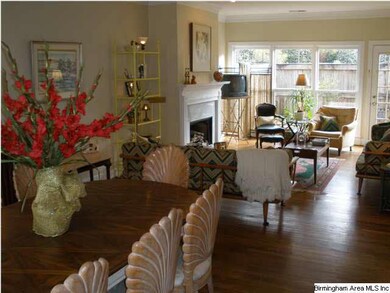 Living room has fireplace and hardwoods.