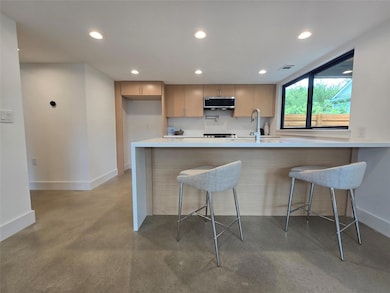Kitchen with stainless steel microwave, concrete 