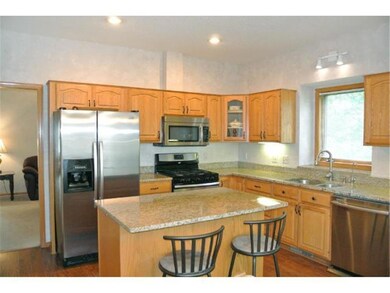 Under cabinet lighting, large windows, center isla