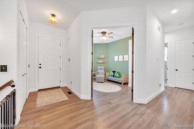Entryway featuring light wood finished floors and 10 foot ceilings throughout!