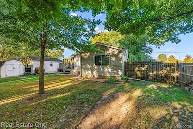 Rear view of property with a shed