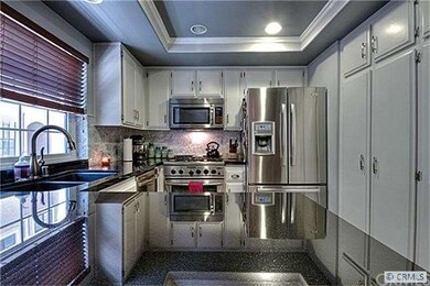 STAINLESS APPLIANCES, COFFERED CEILING WITH CANNED