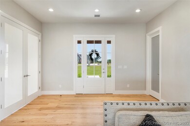 Open foyer with hardwoods flows to the study throu