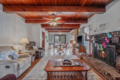 Living room with light wood-type flooring, ceiling