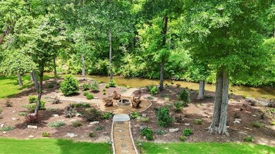 The soothing sound of flowing water, lush landscaping, and complete backyard privacy create an unforgettable setting.
