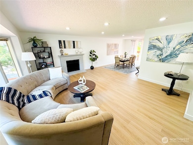 The living room is expansive and has a wood fireplace.
