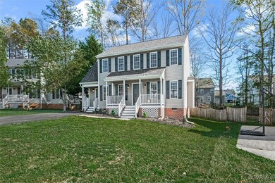Colonial-style house featuring fence, covered porc