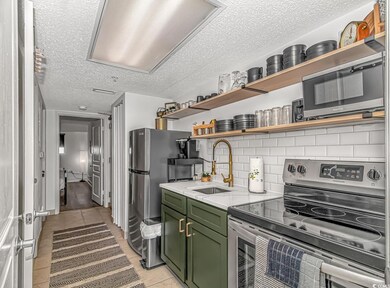 Kitchen with sink, green cabinetry, stainless stee