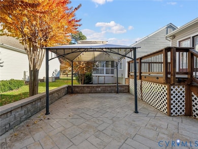 Spacious stamped-concrete patio with pergola—perfect for outdoor dining or entertaining beneath the shade of mature trees.