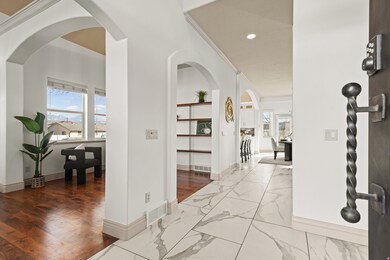 Corridor with arched walkways, recessed lighting, and dark marble finish floors