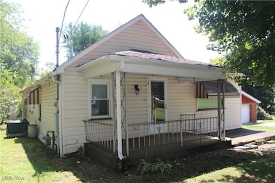 View of front facade featuring roof with shingles and a garage