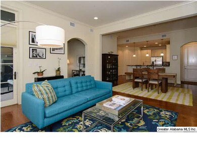 Open floor plan with crown molding and hardwood fl