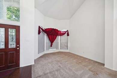 Entrance foyer featuring lofted ceiling and hardwo