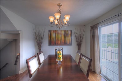 Dining room has hardwood floors and sliding doors 