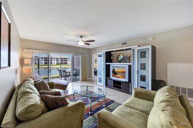 Living room featuring ceiling fan, light tile patt