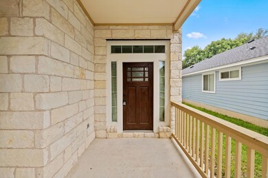 Doorway to property with stone siding