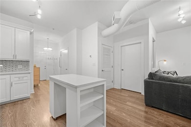 Kitchen featuring light countertops, open shelves,