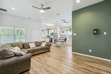 Living area featuring light wood-type flooring, ba